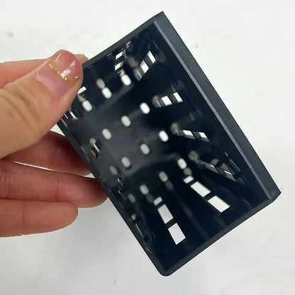 A black plant support with clips for holding aquatic plants in fish tanks
